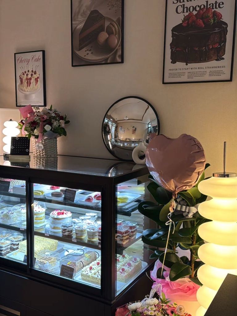 SweetByKim dessert counter filled with pastries and flowers